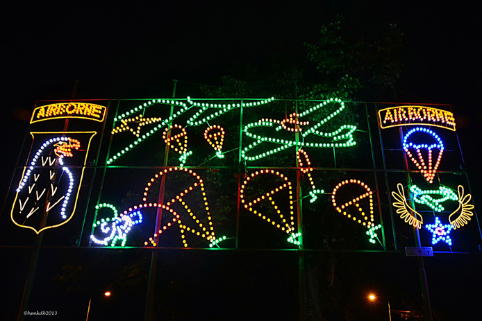 Colorful lights arranged to depict an airdrop of liberation forces.