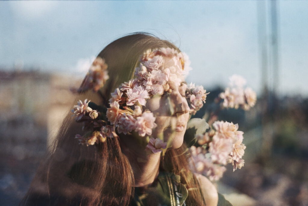 Example of the Double Exposure technique. A photo of a girl and flowers are overlayed to create a dreamy effect.